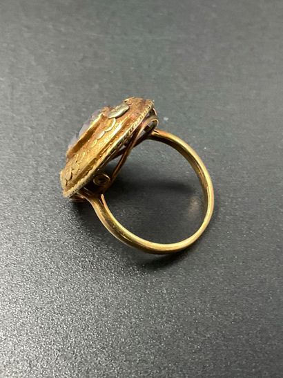 750 thousandths gold ring set with a white...