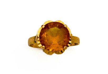 A 750-thousandths gold ring in the shape...