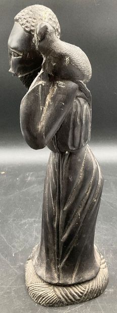 A statuette depicting a saint carrying a...