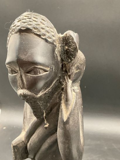 A statuette depicting a saint carrying a...