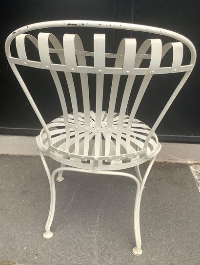 A riveted iron garden chair with a slatted...
