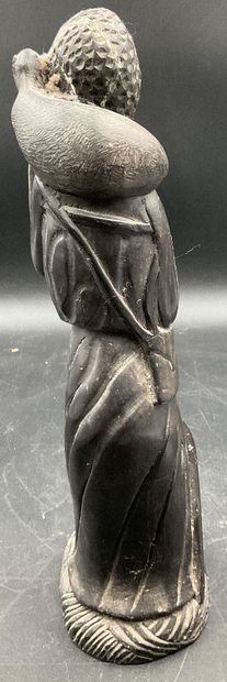 A statuette depicting a saint carrying a...