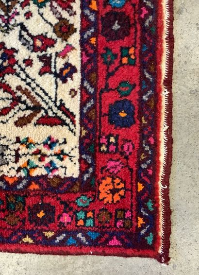 2 rugs: a handwoven wool Bukhara-style hallway...