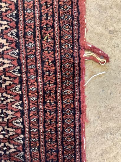 2 rugs: a handwoven wool Bukhara-style hallway...