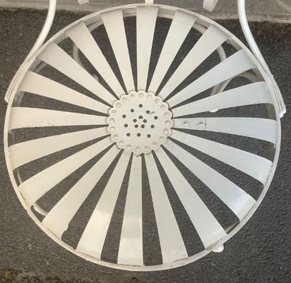 A riveted iron garden chair with a slatted...