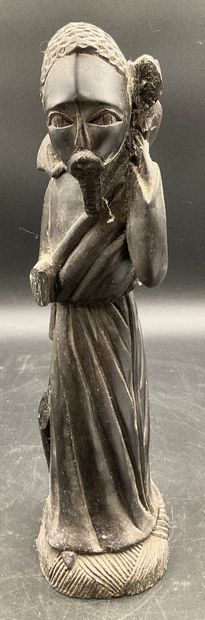 A statuette depicting a saint carrying a...