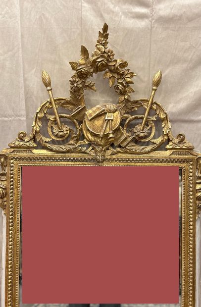 A molded, carved and gilded wood pediment...