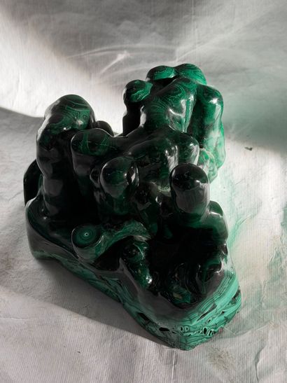 Free-form group in carved malachite. 
20th...