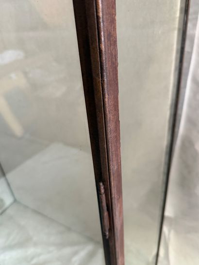 Large wrought-iron display case resting on...