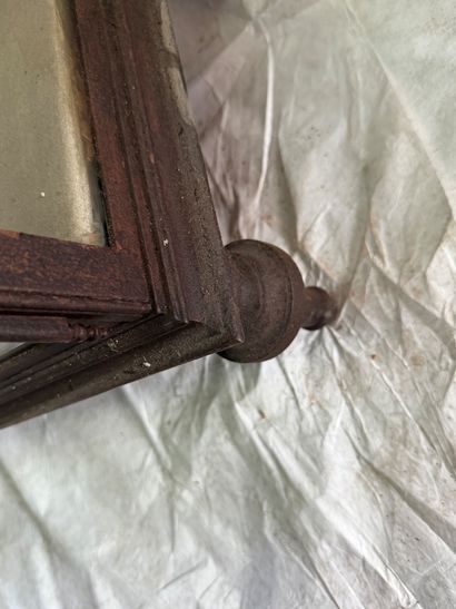 Large wrought-iron display case resting on...