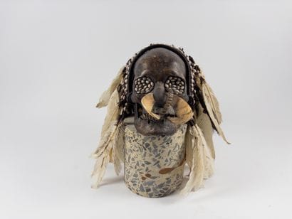 Asmat. 
Trophy skull inlaid with seeds in...