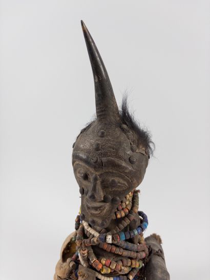 Songye. 
Fetish statuette wrapped in pearl...