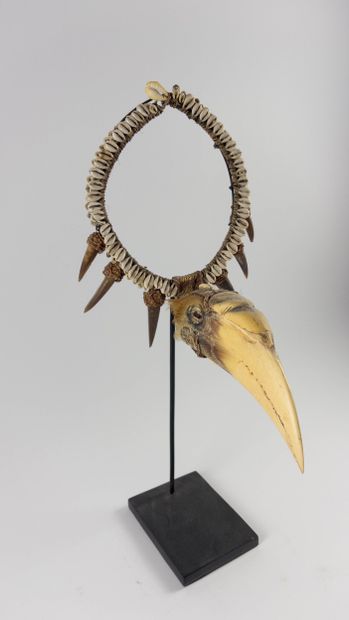 Asmat. 
Hunter's ornament decorated with...