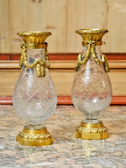 A pair of cut-crystal vases with chased and...