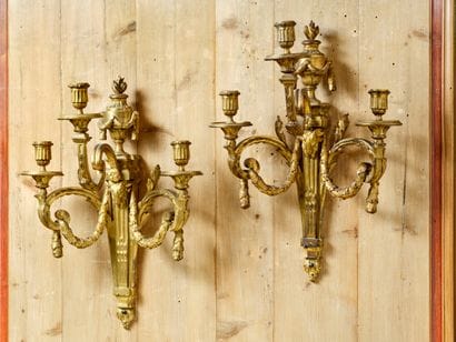 Pair of three-light sconces in chased and...