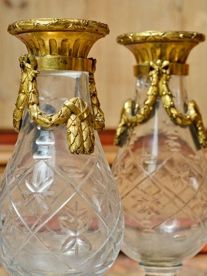 A pair of cut-crystal vases with chased and...