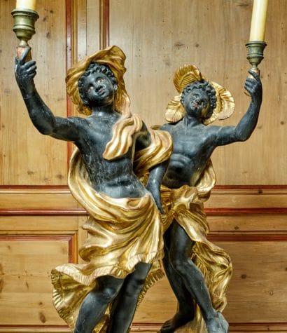 A large pair of carved, gilded and patinated...