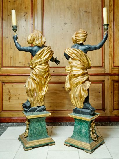 A large pair of carved, gilded and patinated...