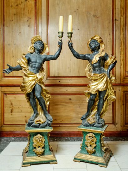 A large pair of carved, gilded and patinated...