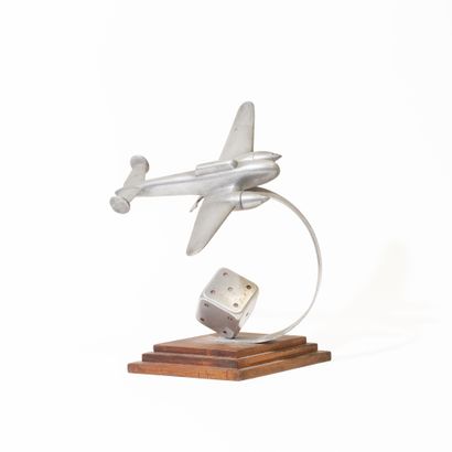 Aluminum airplane with dice at the base....