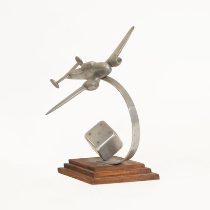Aluminum airplane with dice at the base....