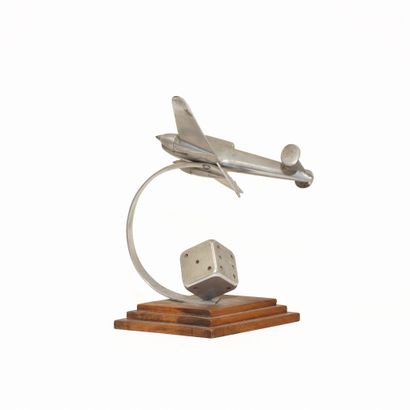 Aluminum airplane with dice at the base....