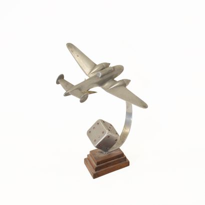 Aluminum airplane with dice at the base....