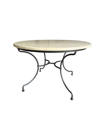 Round-top table in travertine on four curved...