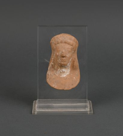Archaic female votive head with round curls...
