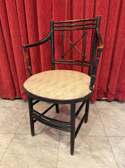 Suite of four blackened wood ARMCHAIRS, cross-braced...