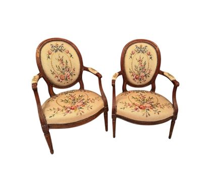 Two armchairs in molded natural wood, the...