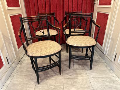 Suite of four blackened wood ARMCHAIRS, cross-braced...