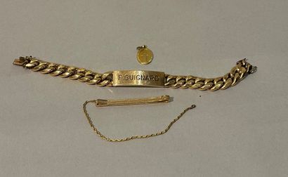 A set of gold-plated jewelry including a...