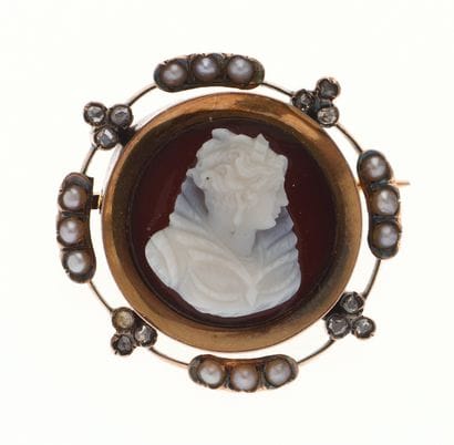 Antique brooch
centering a cameo on brown...