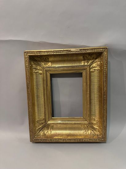 Wood and gilded stucco frame decorated with...