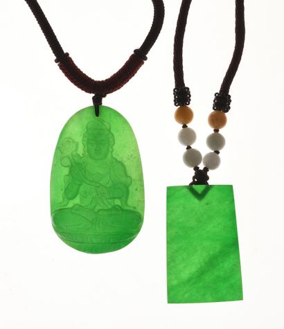 China
Two jade pendants: one oval with carved...
