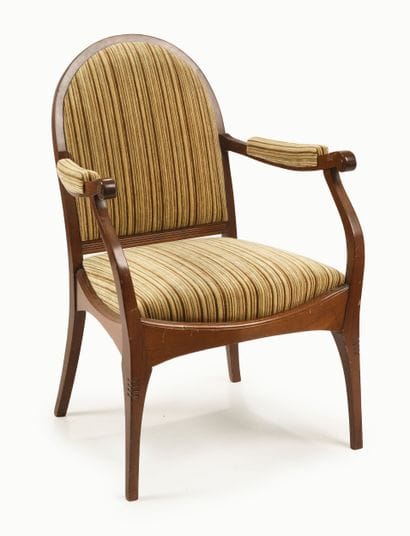 Stained mahogany armchair with a rounded...