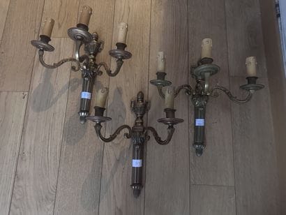 A set of three gilded cast-bronze wall sconces,...
