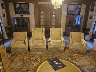 Two velvet wingback armchairs. Signs of wear....