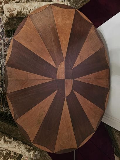 Oval table made of veneered wood with fan-shaped...