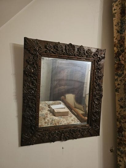 MIRROR in walnut, carved with flowers and...