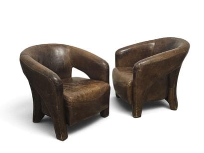 Pair of club or pilot armchairs in tan leather....