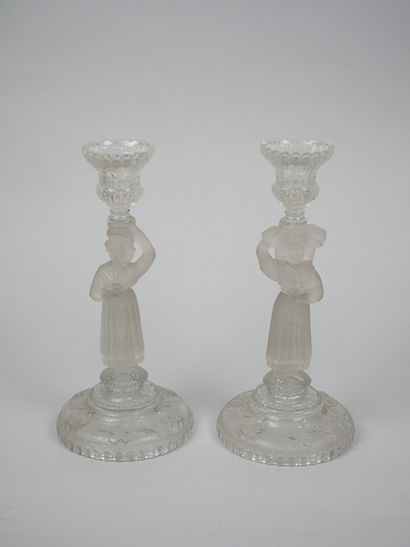 A pair of candlesticks in partially frosted...