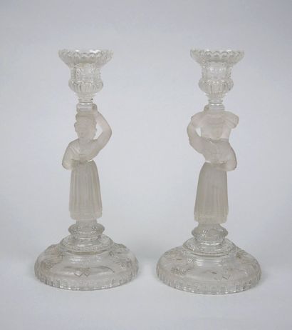 A pair of candlesticks in partially frosted...