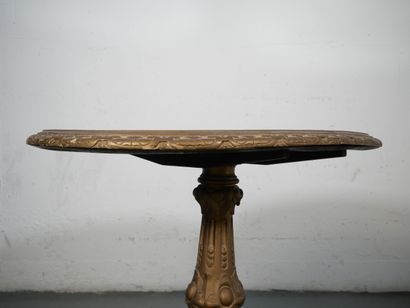 Gilded wood pedestal table carved with scrolls...