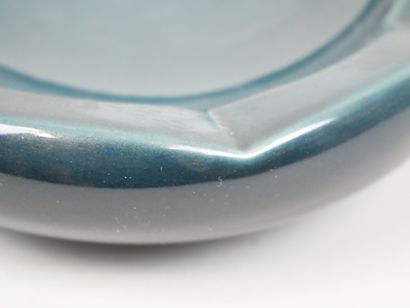 Blue earthenware ashtray with wavy edges.
Dimensions:...