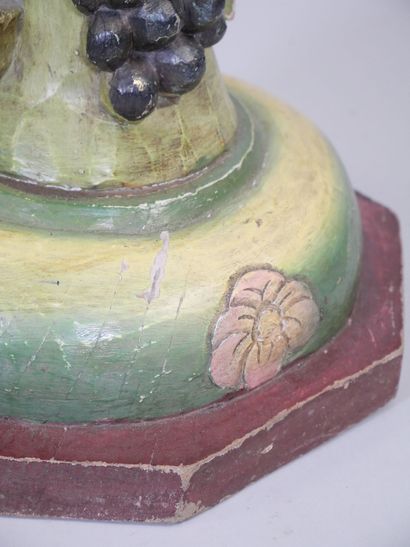 Wooden torso column with polychrome vine...