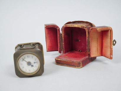 Small travel clock with white enameled dial...