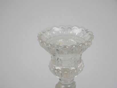 A pair of candlesticks in partially frosted...