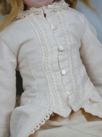 Porcelain head doll, fixed blue eyes, closed...